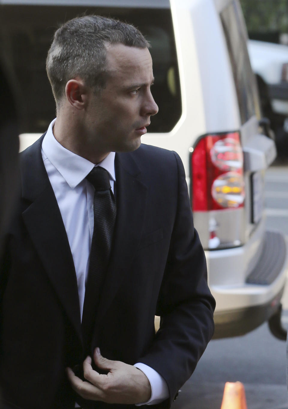 Oscar Pistorius arrives at the high court in Pretoria, South Africa, Thursday, May 8, 2014. Pistorius' defense lawyer has called an anesthetist to testify at the runner's murder trial. Pistorius is charged with murder for the shooting death of his girlfriend, Reeva Steenkamp, on Valentines Day in 2013. (AP Photo/Themba Hadebe)