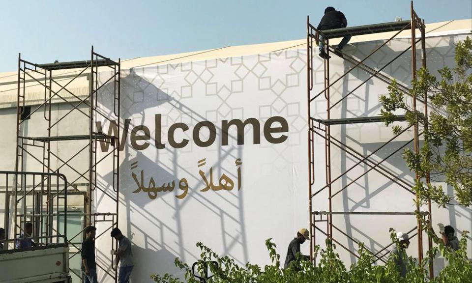 Workers place a banner at the pavilion where the US-hosted event ‘Peace to Prosperity’ takes place outside the Four Seasons Hotel in Manama, Bahrain, on Monday.