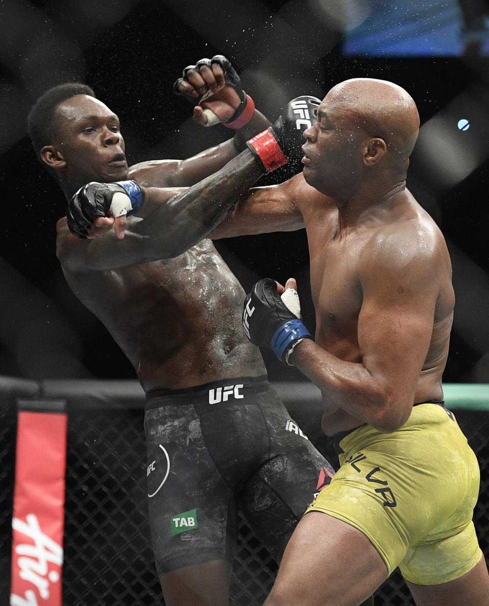 Nigeria's Israel Adesanya, left, and Brazil's Anderson Silva fight during their middlewesight bout at the UFC 234 event in Melbourne, Australia, Sunday, Feb. 10, 2019. (AP Photo/Andy Brownbill)