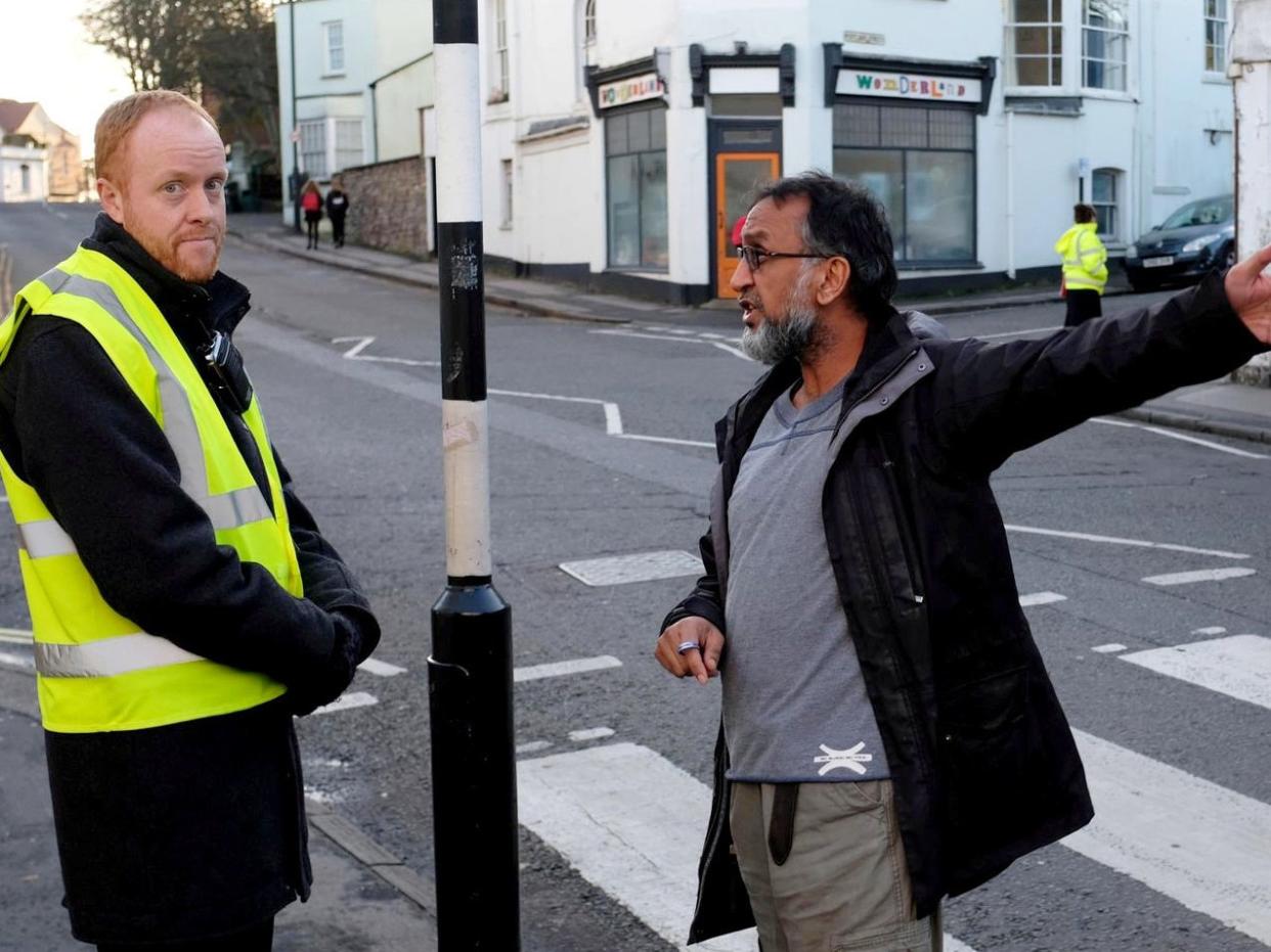 Bobby Sehdev of nearby newsagent Monikas remonstrates with one of the teachers: Bristol Live/SWNS