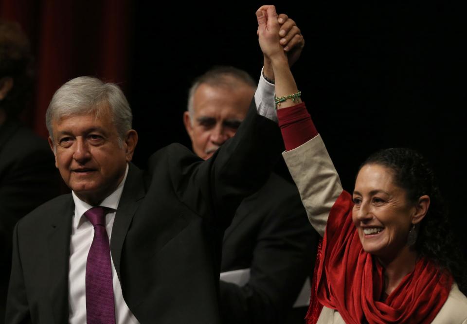 Presidential hopeful Andres Manuel Lopez Obrador, left, and Claudia Sheinbaum, coordinator of the Morena political party, hold hands at an event at the National Auditorium in Mexico City, Monday, Nov. 20, 2017. The ruling MORENA party announced early this month Sheinbaum as its candidate for the upcoming Mexican presidential elections, but runner-up and former Foreign Minister Marcelo Ebrard has said the process is marred with irregularities.