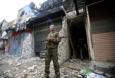 A member of the joint Palestinian security force stands guard inside the Ain el-Hilweh refugee camp near Sidon, southern Lebanon, April 13, 2017. REUTERS/Ali Hashisho