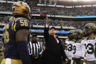 President Donald Trump throws the coin before the start of the Army-Navy college football game in Philadelphia, Saturday, Dec. 14, 2019. (AP Photo/Jacquelyn Martin)