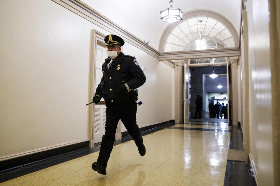 A Capitol Police officer responds to pro-Trump rioters inside the Capitol on Jan. 6, 2021. (Ting Shen / Bloomberg via Getty Images file)