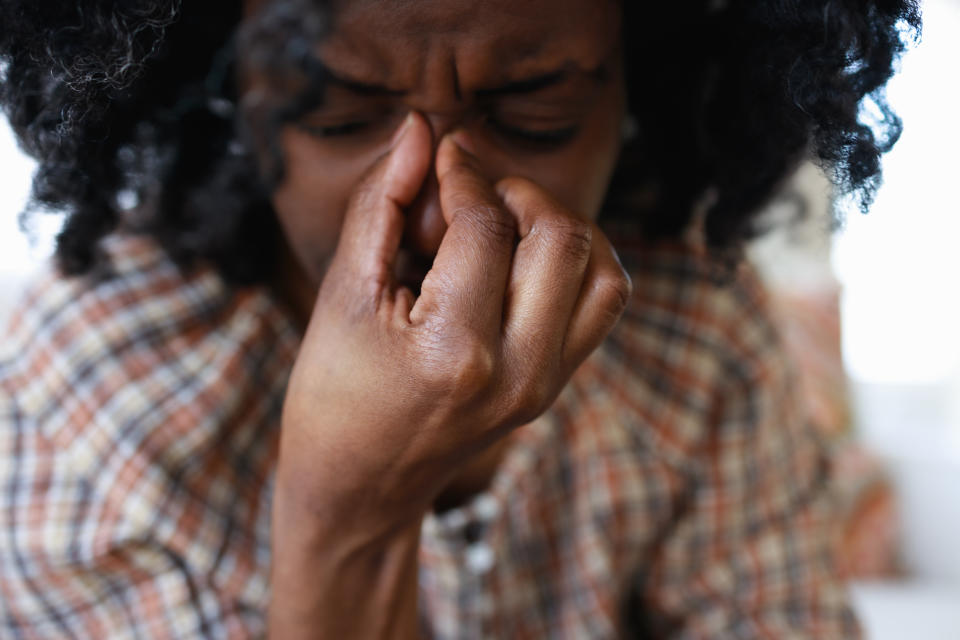 Close-up of mid adult woman suffering from a migraine 