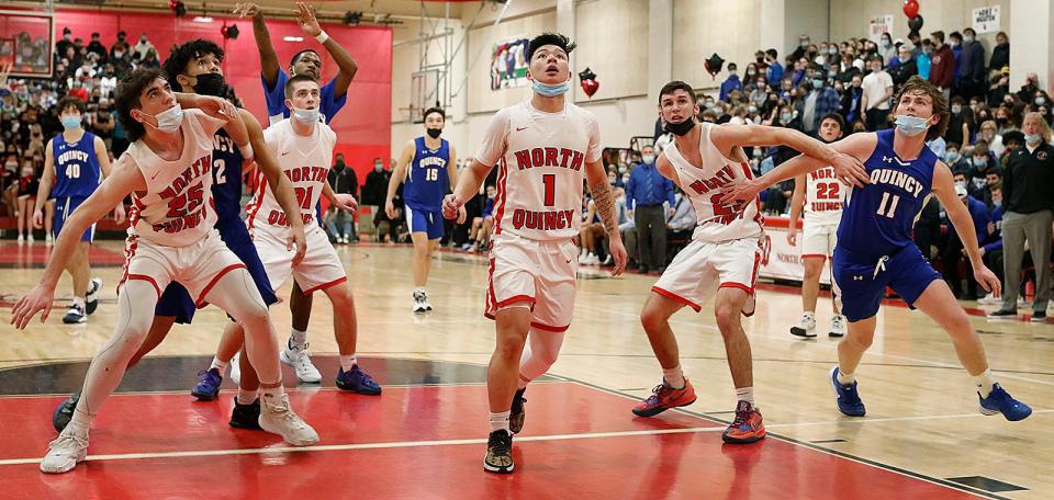 North Quincy's Nikko Mortel (No. 1) looks for a rebound. North Quincy hosted Quincy in boys basketball on Friday, Jan. 21, 2022.