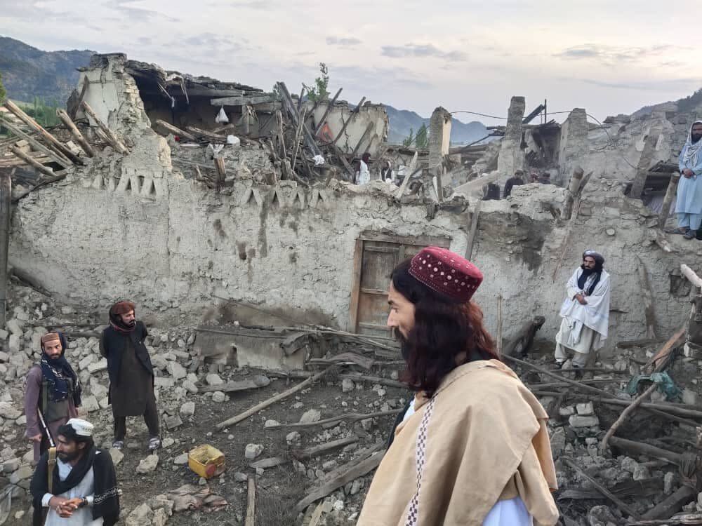 In this photo released by a state-run news agency Bakhtar, Afghans look at destruction caused by an earthquake in the province of Paktika, on Wednesday.