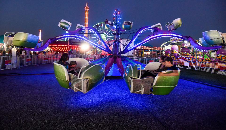 Fairgoers ride carnival rides at the Alabama National Fair in Montgomery, Al., on opening night Friday October 8, 2021. 