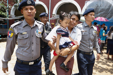 Detained Reuters journalist Kyaw Soe Oo holds his daughter as he leaves Insein court in Yangon, Myanmar, July 23, 2018. REUTERS/Ann Wang