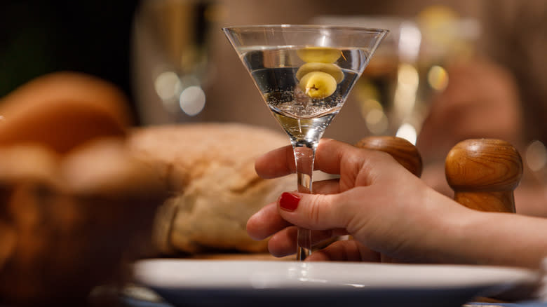 Person holding a martini