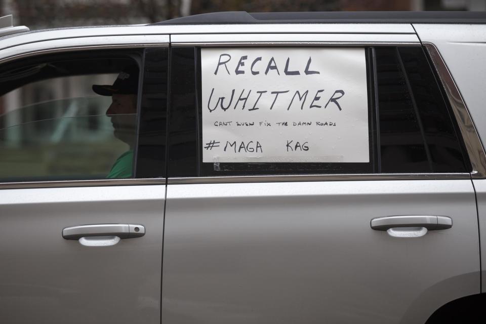 A man sits in his car while driving towards the Capitol along with many others to express their unhappiness with Governor Gretchen Whitmer's Stay Safe, Stay Home executive order (Getty Images)