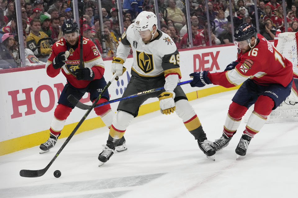 Florida Panthers center Aleksander Barkov (16) defends Vegas Golden Knights center Ivan Barbashev (49) during the third period in Game 4 of the NHL hockey Stanley Cup Finals, Saturday, June 10, 2023, in Sunrise, Fla. The Vegas Golden Knights defeated the Florida Panthers 3-2. (AP Photo/Lynne Sladky)