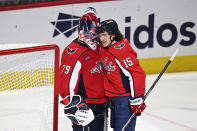 Washington Capitals goaltender Charlie Lindgren (79) and left wing Sonny Milano (15) celebrate after an NHL hockey game against the Boston Bruins, Monday, April 15, 2024, in Washington. The Capitals won 2-0. (AP Photo/Nick Wass)