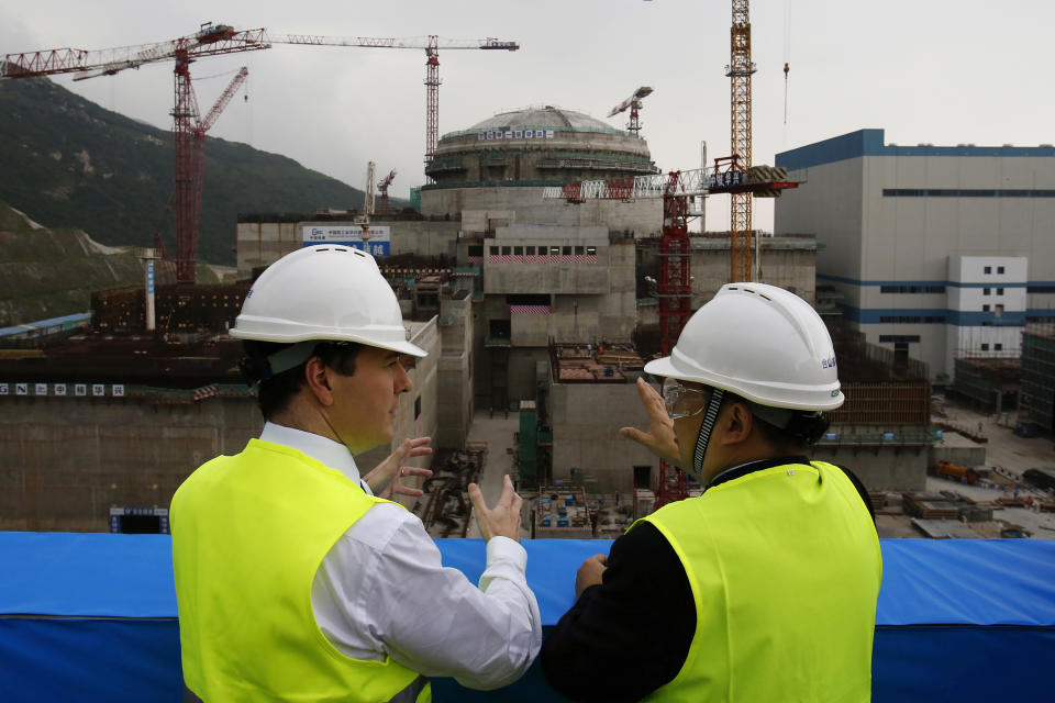 FILE - In this Oct. 17, 2013, file photo, then British Chancellor of the Exchequer George Osborne, left, chats with Taishan Nuclear Power Joint Venture Co. Ltd. General Manager Guo Liming as he inspects a nuclear reactor under construction at the nuclear power plant in Taishan, southeastern China's Guangdong province. The Taishan nuclear plant near Hong Kong suffered five broken fuel rods in a reactor but no radioactivity leaked, the government said Wednesday in its first confirmation of the incident that prompted concern over the facility’s safety. (AP Photo/Bobby Yip, Pool, File)