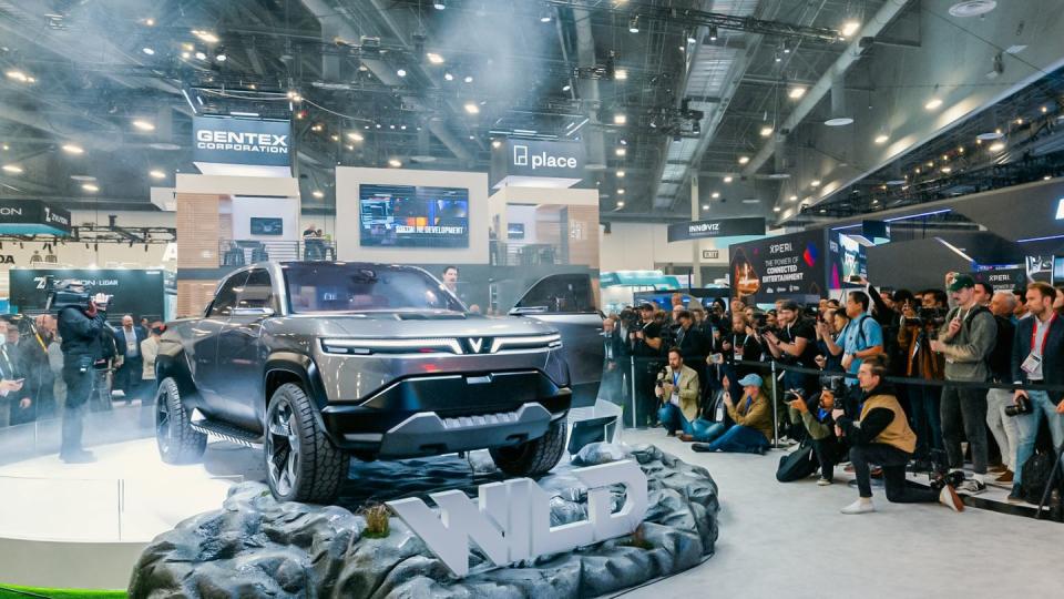 a crowd of people at a car show