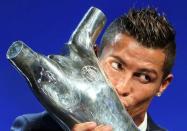 Real Madrid's Cristiano Ronaldo of Portugal kisses the Best Player UEFA 2015/16 Award during the draw ceremony for the 2016/2017 Champions League Cup soccer competition at Monaco's Grimaldi in Monaco, August 25, 2016. REUTERS/Eric Gaillard