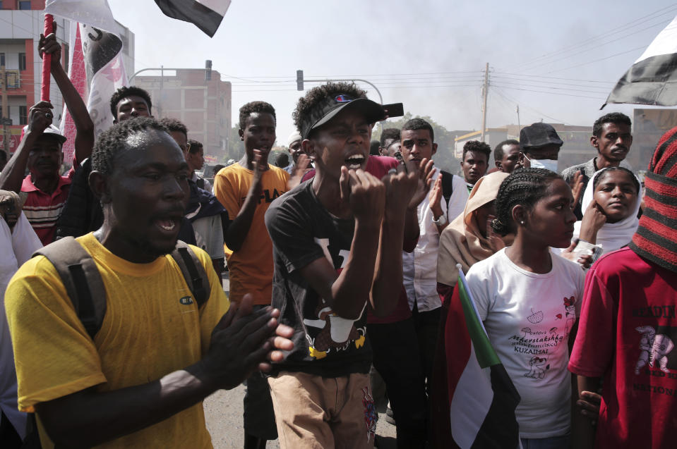 People chant slogans during a protest to denounce the October 2021 military coup, in Khartoum, Sudan, Sunday, Jan. 9, 2022. The United Nations said Saturday it would hold talks in Sudan to try to get the country's democratic transition back on track after it was derailed by the coup. (AP Photo/Marwan Ali)