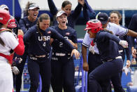 United States' Kelsey Stewart (7) is greeted at the plate by her teammates following her game winning home run against Japan in the seventh inning of a softball game at the 2020 Summer Olympics, Monday, July 26, 2021, in Yokohama, Japan. (AP Photo/Sue Ogrocki)