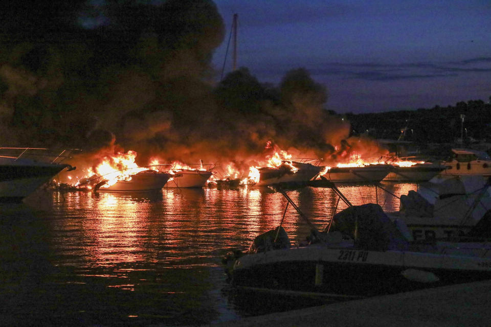 Boats are on fire in Medulin, Croatia, early Wednesday, May 15, 2024. A fire early on Wednesday at a marina in northwestern Croatia destroyed 22 boats and caused huge damage but no injuries. (AP Photo/Goran Sebelic, Cropix)