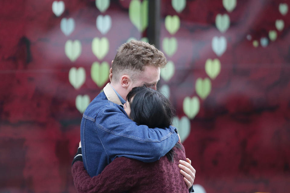 <p>A couple hug at the north end of London Bridge in London, June 4, 2017, after leaving flowers in tribute to the victims of the June 3 terror attack. (Photo: Daneil Leal-Olivas/AFP/Getty Images) </p>