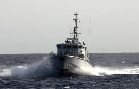 A Libyan coast guard vessel chases away former fishing trawler Golf Azzurro of the Proactiva Open Arms rescue charity in the Western Mediterranean Sea August 15, 2017. REUTERS/Yannis Behrakis