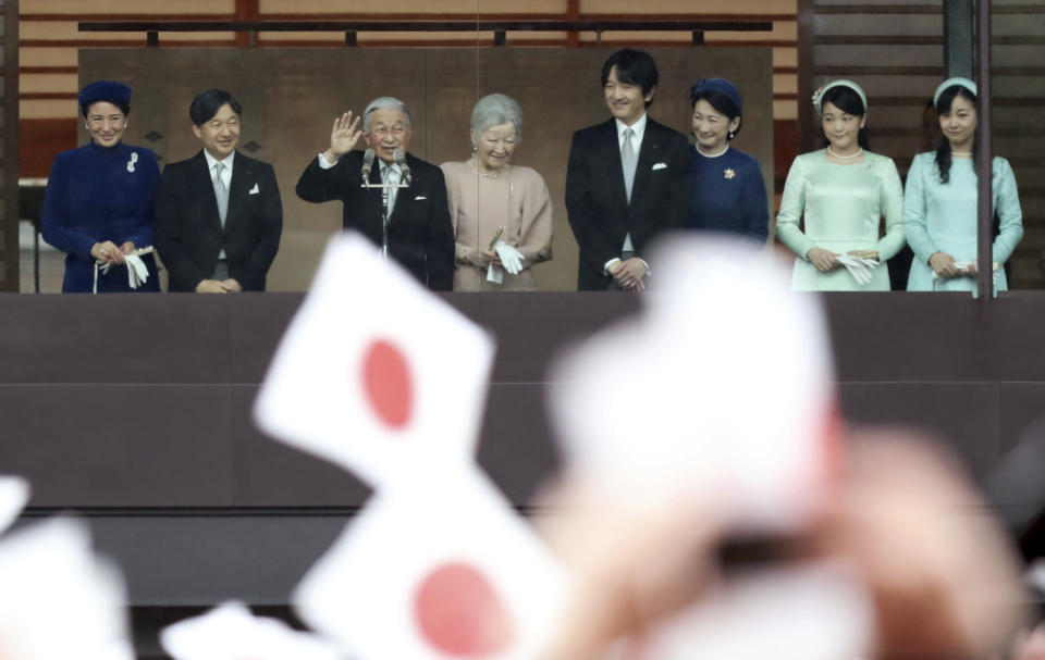 Japan's Emperor Akihito, third from left, accompanied by his wife Empress Michiko, forth from left, and their family members, waves to well-wishers as they appear on the balcony of the Imperial Palace to mark the emperor's 85th birthday in Tokyo Sunday, Dec. 23, 2018. (AP Photo/Eugene Hoshiko)