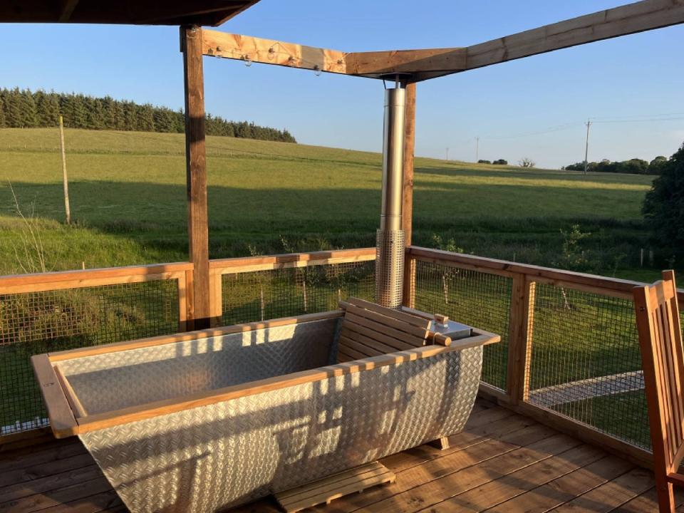 The wood fired bath is perfectly positioned for taking a sunset dip (Helen Wilson-Beevers)