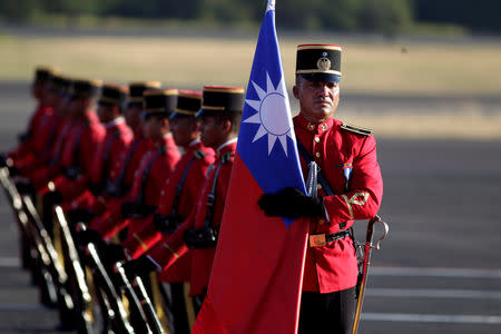 FILE PHOTO: A honor guard holds a Taiwan flag before the arrival of Taiwan's President Tsai Ing-wen at the Oscar Arnulfo Romero International Airport in San Luis Talpa, El Salvador January 12, 2017. REUTERS/Jose Cabezas/File photo