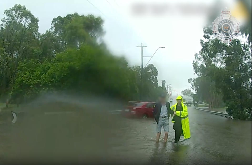 A driver being assisted after becoming stuck in floodwaters in Morayfield, Queensland, on Wednesday. Source: QLD Police