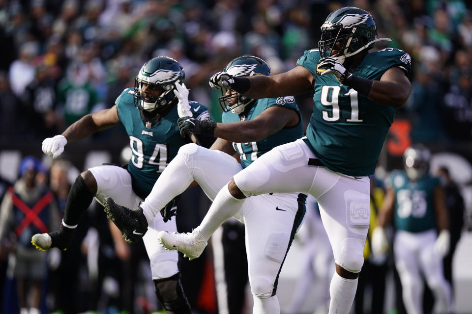 Philadelphia Eagles' Josh Sweat, from left, Javon Hargrave and Fletcher Cox celebrate a tackle by Hargrave during the first half of an NFL football game against the Tennessee Titans, Sunday, Dec. 4, 2022, in Philadelphia. (AP Photo/Chris Szagola)