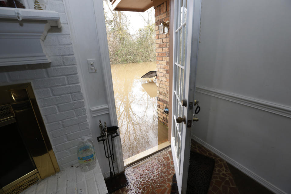 Water from the Pearl River enters this northeast Jackson, Miss., home, Sunday, Feb. 16, 2020. Residents of Jackson braced for the possibility of catastrophic flooding in and around the Mississippi capital as the Pearl River rose precipitously after days of torrential rain. (AP Photo/Rogelio V. Solis)