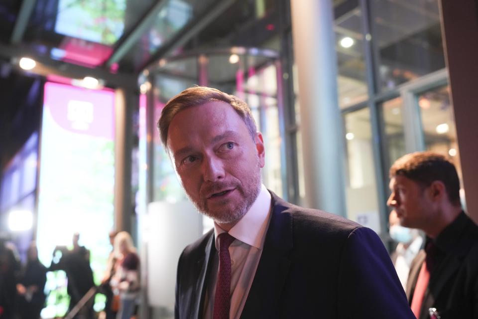 Christian Lindner, FDP party leader, leaves after attending a TV broadcast on the parliamentary elections in Berlin, Sunday, Sept. 26, 2021. Exit polls show the center-left Social Democrats in a very close race with outgoing Chancellor Angela Merkel's bloc in Germany's parliamentary election, which will determine who succeeds the longtime leader after 16 years in power. (AP Photo/Michael Probst)