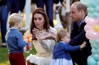 Britain's Prince William and Catherine, Duchess of Cambridge, look on as Prince George plays with a bubble gun and Princess Charlotte plays with baloons at a children's party at Government House in Victoria, British Columbia, Canada, September 29, 2016. REUTERS/Chris Wattie