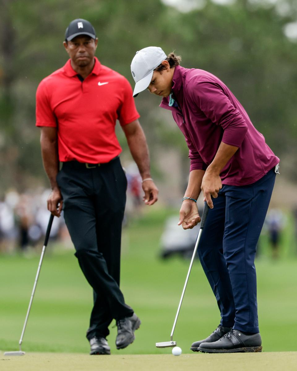 Tiger Woods, left, watches his son Charlie, 15, right, putt during the final round of the PNC Championship golf tournament Sunday, Dec. 17, 2023, in Orlando. Charlie Woods will be playing a pre-qualifier on Thursday in Hobe Sound,the first step before a full qualifier for the Cognizant Classic on the PGA Tour.