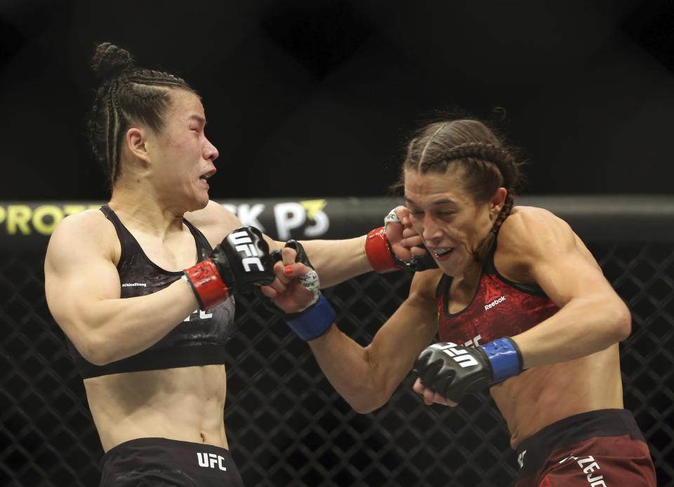 Zhang Weili, left, connects with a punch to Joanna Jedrzejczyk during the second round of a women's strawweight UFC 248 mixed martial arts bout Saturday, March 7, 2020, in Las Vegas. (L.E. Baskow/Las Vegas Review-Journal via AP)