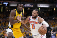 New York Knicks guard Jalen Brunson (11) drives past Indiana Pacers forward Aaron Nesmith, left, during the first half of Game 3 in an NBA basketball second-round playoff series, Friday, May 10, 2024, in Indianapolis. (AP Photo/Michael Conroy)