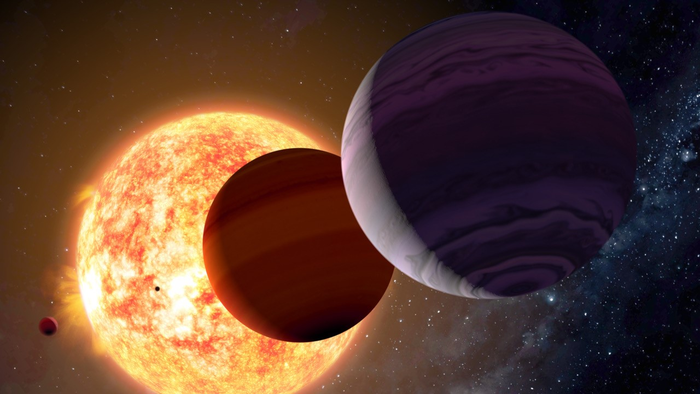 Τέσσερις πλανήτες περιφέρονται γύρω από ένα μεγάλο πορτοκαλί αστέρι.  Χιλιάδες άλλα μακρινά αστέρια είναι διάσπαρτα στο φόντο