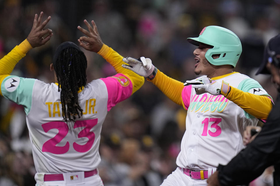 San Diego Padres' Manny Machado, right, celebrates with teammate Fernando Tatis Jr. after hitting a two-run home run during the eighth inning of a baseball game against the St. Louis Cardinals, Friday, Sept. 22, 2023, in San Diego. (AP Photo/Gregory Bull)