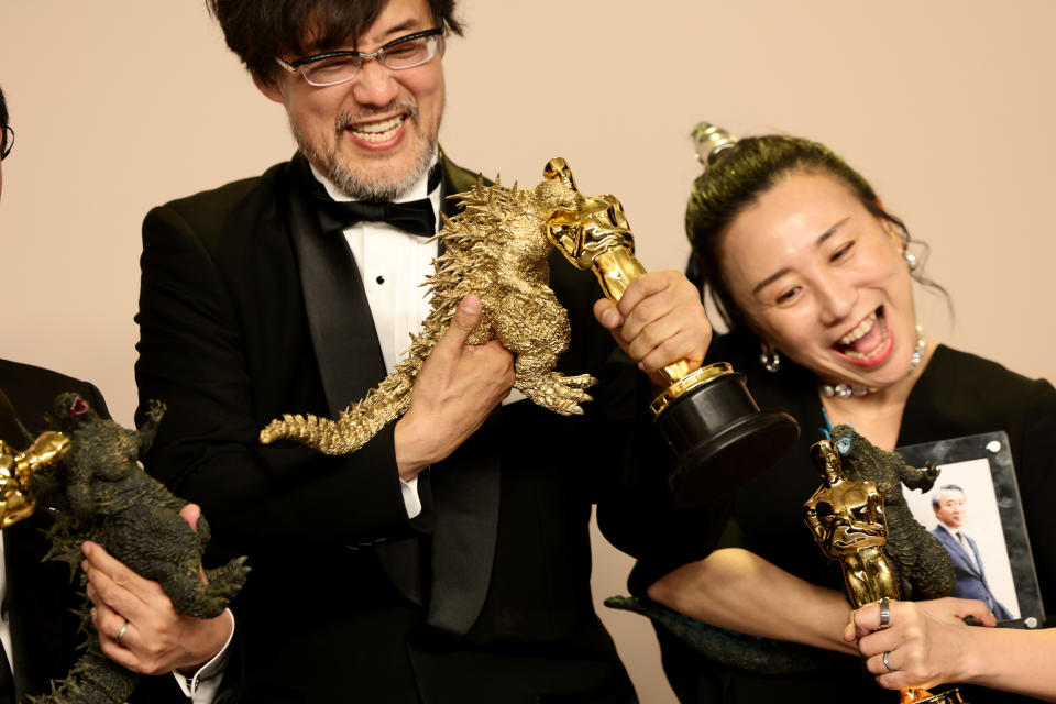 HOLLYWOOD, CALIFORNIA - MARCH 10: (L-R) Takashi Yamazaki and Kiyoko Shibuya, winners of the Best Visual Effects award for “Godzilla Minus One”, pose in the press room during the 96th Annual Academy Awards at Ovation Hollywood on March 10, 2024 in Hollywood, California. (Photo by Arturo Holmes/Getty Images)