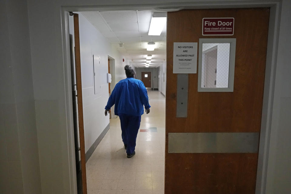 Alliance Healthcare System hospital Environmental Service Manager Ardency Baird walks along one of the empty corridors of the Holly Springs, Miss., facility Feb. 29, 2024. One of the requirements to be approved as a rural emergency hospital is the closing of all inpatient beds and providing 24/7 emergency care. (AP Photo/Rogelio V. Solis)