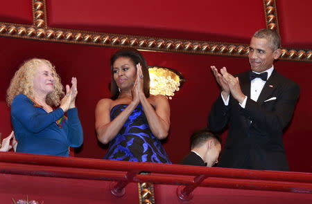 U.S. President Barack Obama and first lady Michelle Obama (C) attend the Kennedy Center Honors at the Kennedy Center in Washington December 6, 2015. REUTERS/Yuri Gripas