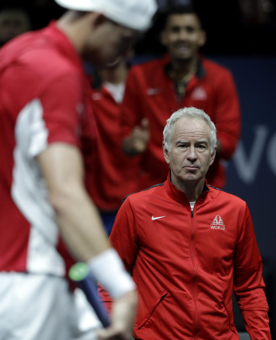 FILE - World's John Isner, left, walks past his captain John McEnroe, right, during their Laver Cup tennis match against Europe's Dominic Thiem in Prague, Czech Republic, Sept. 22, 2017. The latest in a series of attempts to help pickleball find a footing on television is coming Sunday, April 2, 2023, when McEnroe, Andy Roddick, Andre Agassi and Michael Chang take part in a made-for-TV exhibition in Hollywood, Florida. (AP Photo/Petr David Josek, File)