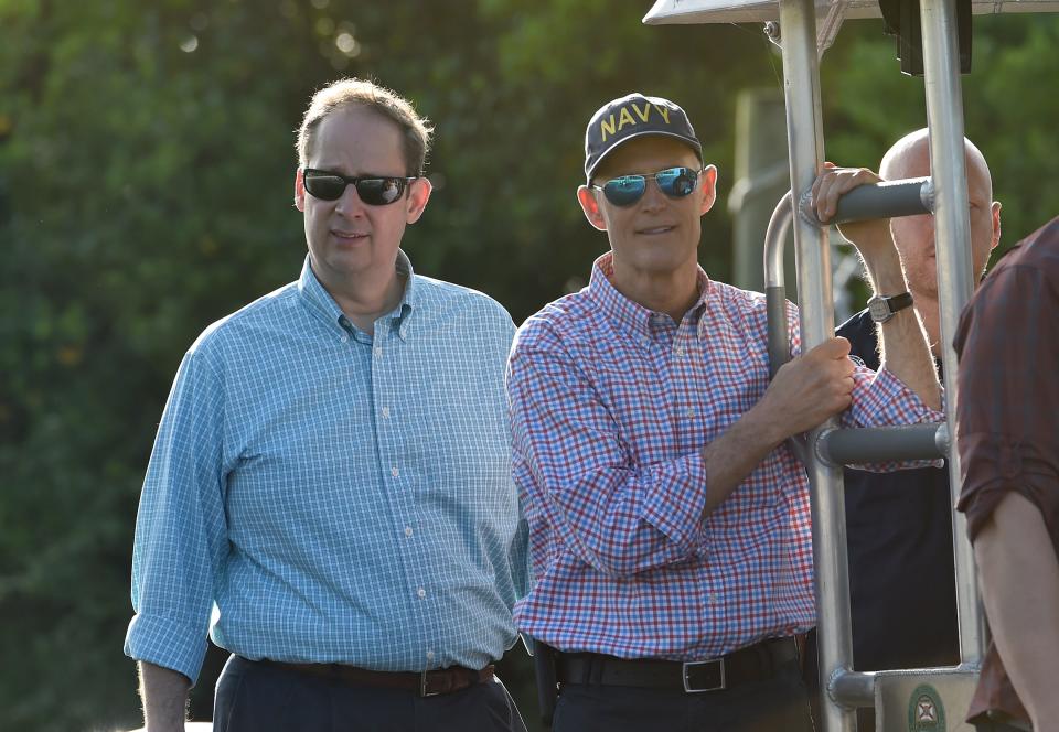 Florida Gov. Rick Scott (right) and Sen. Joe Negron tour the algae affected areas of the St. Lucie River from a Florida Fish and Wildlife Conservation boat on Friday, August 10, 2018, in Stuart.