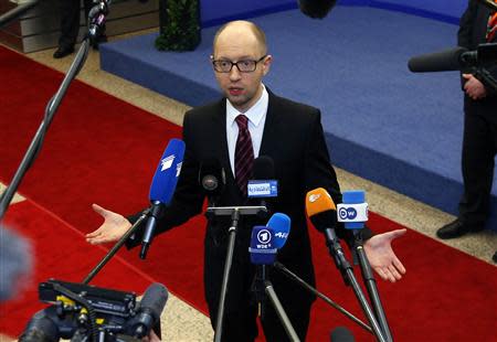 Ukraine's Prime Minister Arseniy Yatsenyuk talks to reporters while leaving a European Union leaders summit in Brussels March 21, 2014. REUTERS/Yves Herman