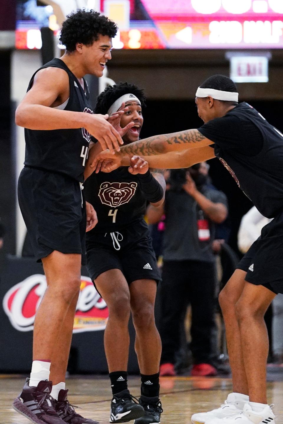 Missouri State forward Gaige Prim, left, celebrates with guards Ja'Monta Black, center, and Isiaih Mosley after they defeated Loyola Chicago in an NCAA college basketball game in Chicago, Saturday, Jan. 22, 2022. (AP Photo/Nam Y. Huh)