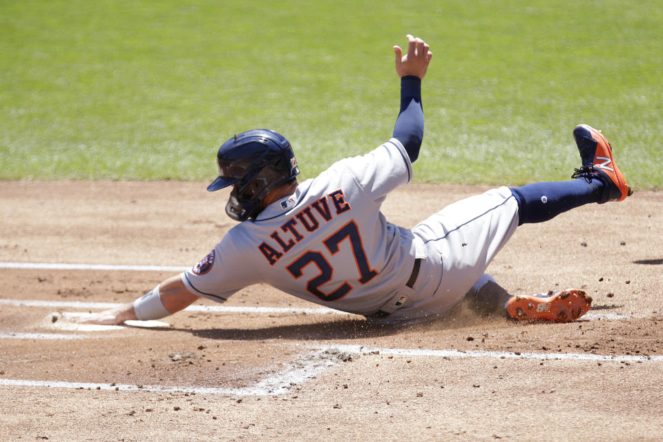 Houston Astros' Jose Altuve scores on a sacrifice fly against the Minnesota Twins in the first inning of a baseball game, Sunday, June 13, 2021, in Minneapolis. (AP Photo/Andy Clayton-King)