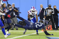 Tennessee Titans running back Derrick Henry (22) dives into the end zone for a touchdown ahead of Buffalo Bills cornerback Levi Wallace (39) in the second half of an NFL football game Monday, Oct. 18, 2021, in Nashville, Tenn. (AP Photo/Mark Zaleski)