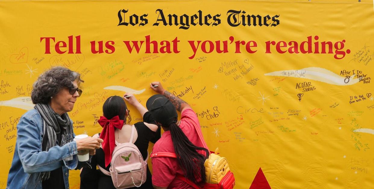 People sign what books they are reading during the LA Times Book Festival.