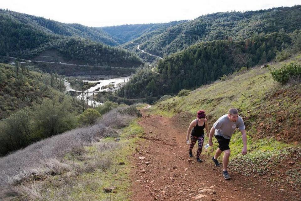 Ruby Ledford of Auburn and Dallas Stevens of Grass Valley walk up an especially steep trail as it heads toward the Foresthill Bridge in the Auburn State Recreation Area.