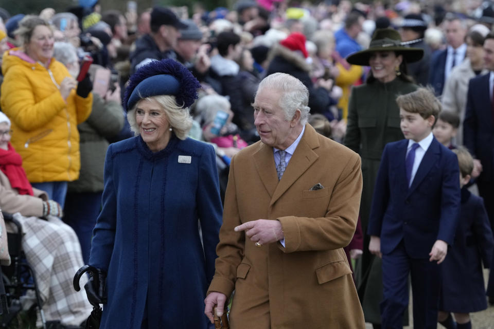 King Charles III, centre, and Camilla, the Queen Consort lead the Royal Family as they arrive to attend the Christmas day service at St Mary Magdalene Church in Sandringham in Norfolk, England, Sunday, Dec. 25, 2022. (AP Photo/Kirsty Wigglesworth)